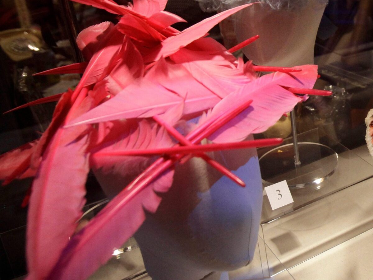 In this Thursday, Sept. 29, 2011 photo, fuchsia goose feathers adorn a 1995 hat by Philip Treacy, left, and guinea fowl feathers form the multi-colored pattern on a linen hat from 1700-1800 displayed in the exhibit "Hats: An Anthology by Stephen Jones," at the Bard Graduate Center in New York. (AP Photo/Kathy Willens)