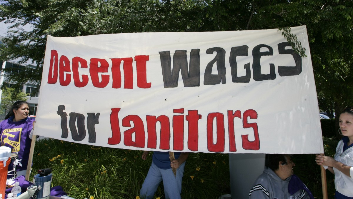 Striking Yahoo janitors and supporters hold a sign during a rally in front of Yahoo headquarters in Sunnyvale, Calif., Tuesday, May 20, 2008. (AP Photo/Paul Sakuma)