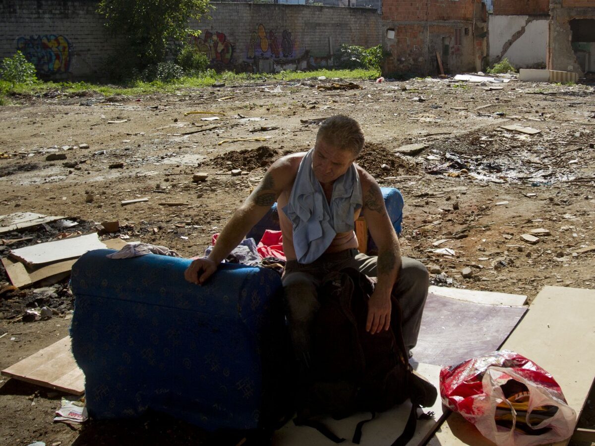 A homeless man sits on a sofa where houses were demolished in the Favela do Metro shantytown in Rio de Janeiro, Brazil, Wednesday, Feb. 1, 2012. Residents of communities like Metro, located on the surroundings of the Maracana stadium, are being pushed out of their homes to make way for new roads, Olympic venues, and other projects as part of preparations to host the 2014 World Cup and the 2016 Olympics. (AP Photo/Victor R. Caivano)