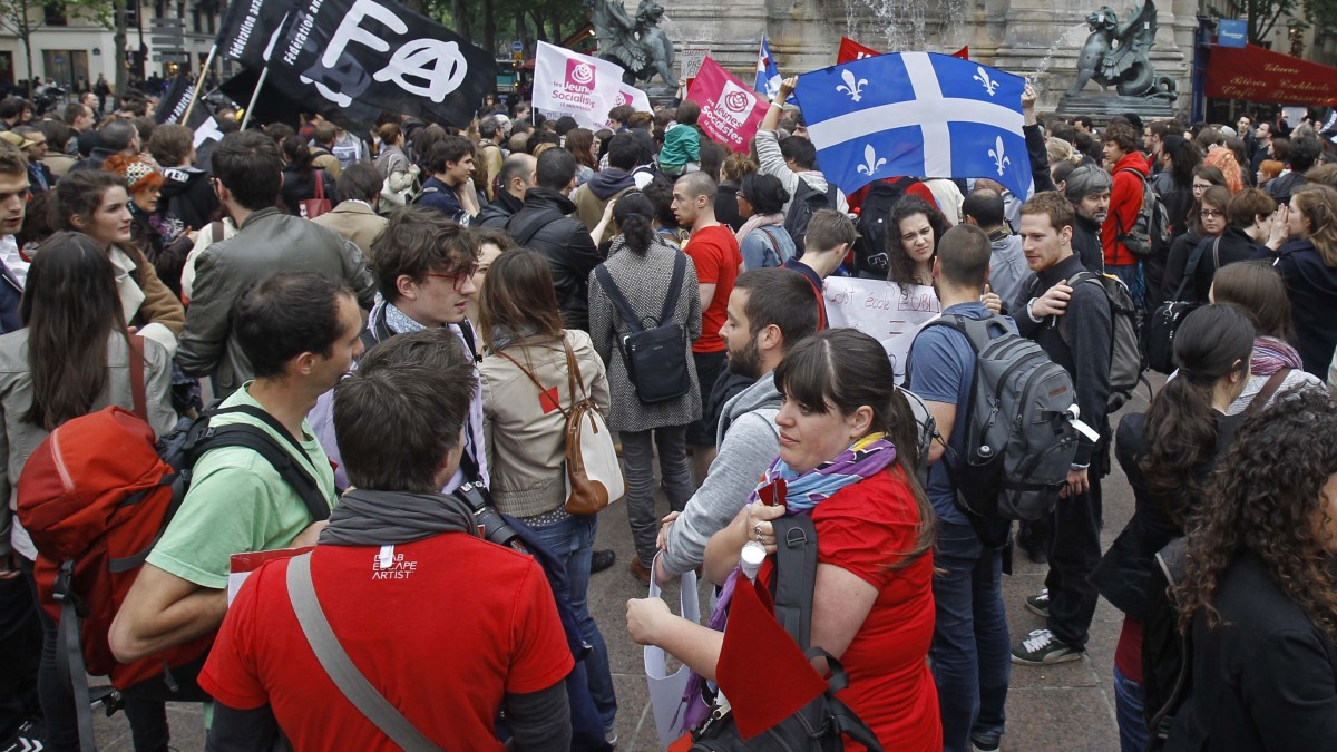 Demonstrators are gathered St. Michel square in Paris, France Tuesday May 22, 2012, to support Quebec students opposing tuition fee hikes and new legislation to limit demonstrations. (AP Photo/Remy de la Mauviniere)