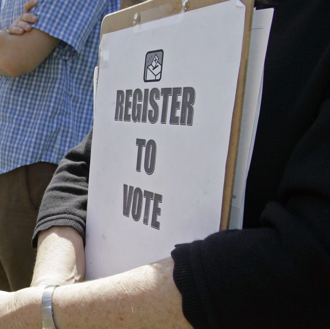 Mary Jo Clark holds a clipboard with forms for students to register to vote during a rally for Barack Obama at Davidson College in Davidson, N.C., Thursday, April 10, 2008. (AP Photo/Chuck Burton)