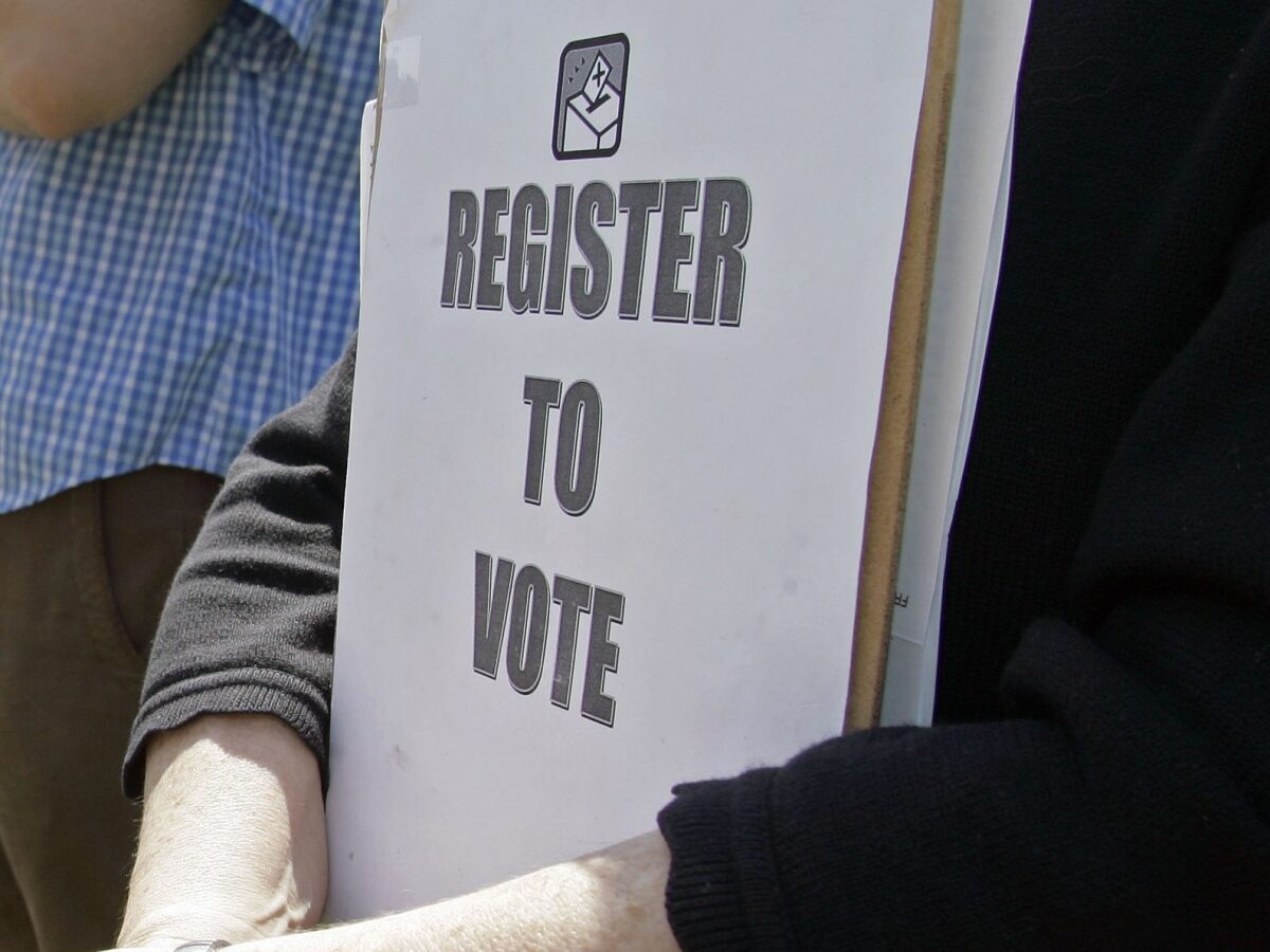 Mary Jo Clark holds a clipboard with forms for students to register to vote during a rally for Barack Obama at Davidson College in Davidson, N.C., Thursday, April 10, 2008. (AP Photo/Chuck Burton)
