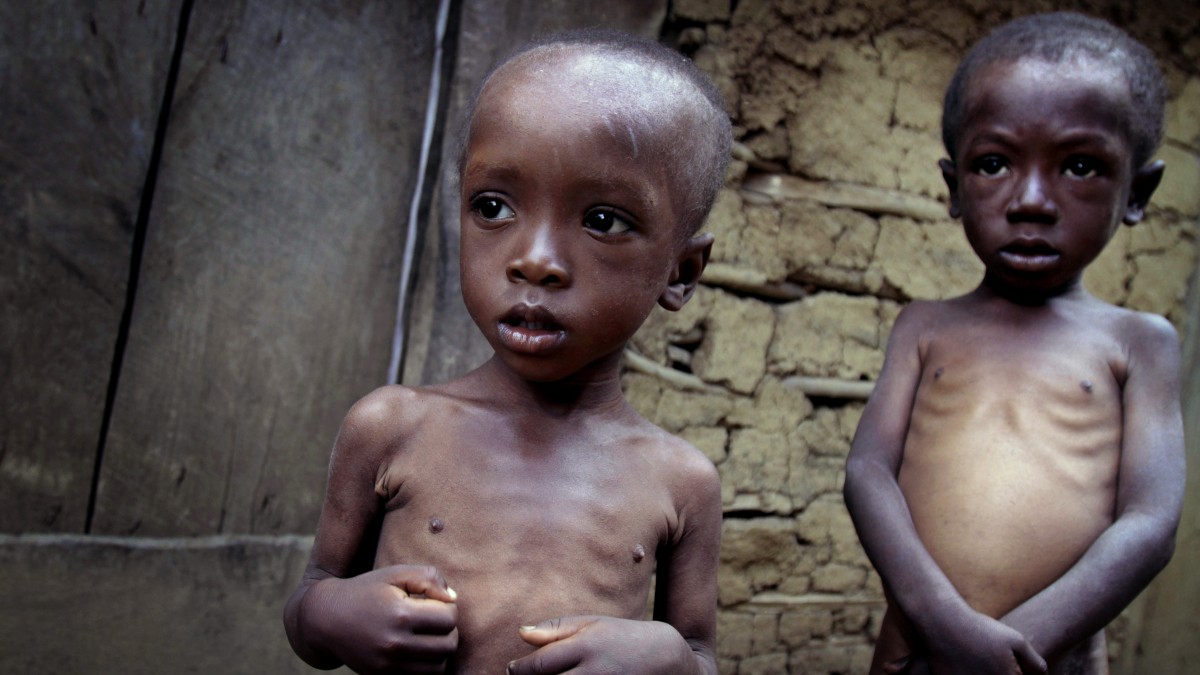 In this picture taken May 10, 2011, malnourished brothers David Paul, left, and Jameson, ages 4 and 6, stand outside their mud-walled home in the rural Kenscoff area in Haiti. (AP Photo/Dieu Nalio Chery)