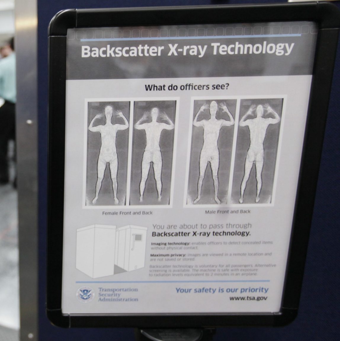 A sign next to a body scanner describes what TSA officers see on their computer screens, asvolunteers go through the first full body scanner installed at O'Hare International Airport , Monday, March 15, 2010, in Chicago. (AP Photo/M. Spencer Green)