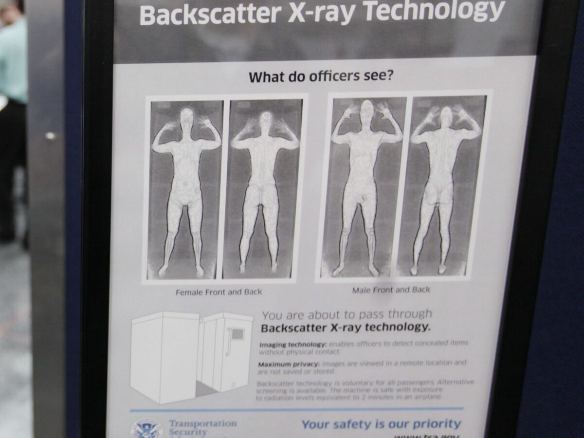 A sign next to a body scanner describes what TSA officers see on their computer screens, asvolunteers go through the first full body scanner installed at O'Hare International Airport , Monday, March 15, 2010, in Chicago. (AP Photo/M. Spencer Green)