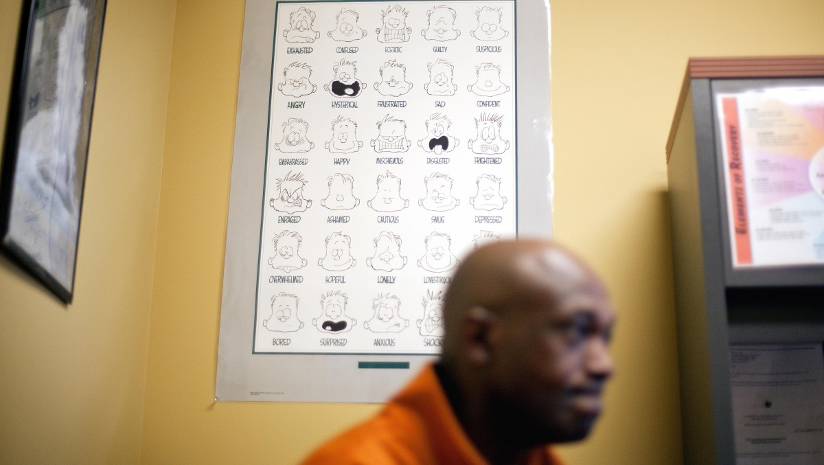 A poster hangs on the wall behind U.S. Army veteran Meshac Snell as he meets with U.S. Department of Veterans Affairs counselor Olga Jantzer, not pictured, in her office Friday, Feb. 3, 2012, in East Point, Ga. (AP Photo/David Goldman)