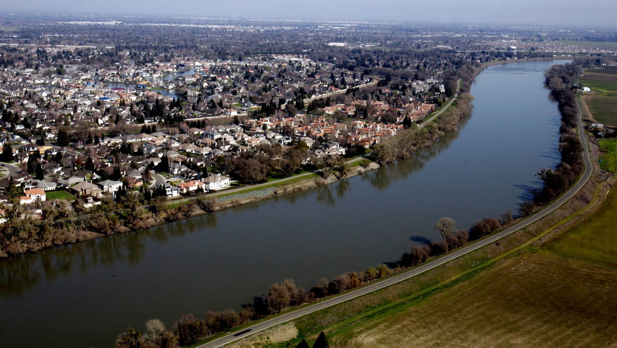In this Feb. 22, 2006 file photo, houses located in the Pocket Area of Sacramento, Calif., are seen along the Sacramento River. (AP Photo/Rich Pedroncelli, file)