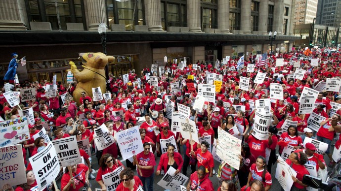 Thousands of public school teachers rally for the second consecutive day outside the Chicago Board of Education district headquarters on Tuesday, Sept. 11, 2012 in Chicago. Teachers walked off the job Monday for the first time in 25 years over issues that include pay raises, classroom conditions, job security and teacher evaluations. (AP Photo/Sitthixay Ditthavong)