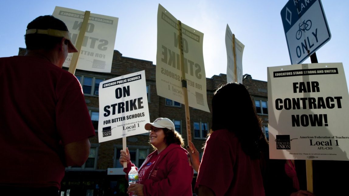 Public school teachers picket outside Amundsen High School in Chicago on the first day of a strike by the Chicago Teachers Union, Monday, Sept. 10, 2012. (AP Photo/Sitthixay Ditthavong)