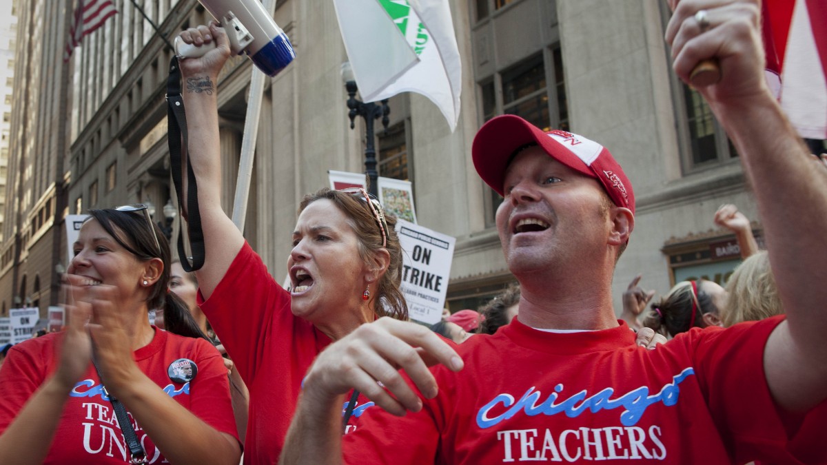 Public school teachers cheer as they march on streets surrounding the Chicago Public Schools district headquarters on the first day of strike action over teachers' contracts on Monday, Sept. 10, 2012 in Chicago. (AP Photo/Sitthixay Ditthavong)
