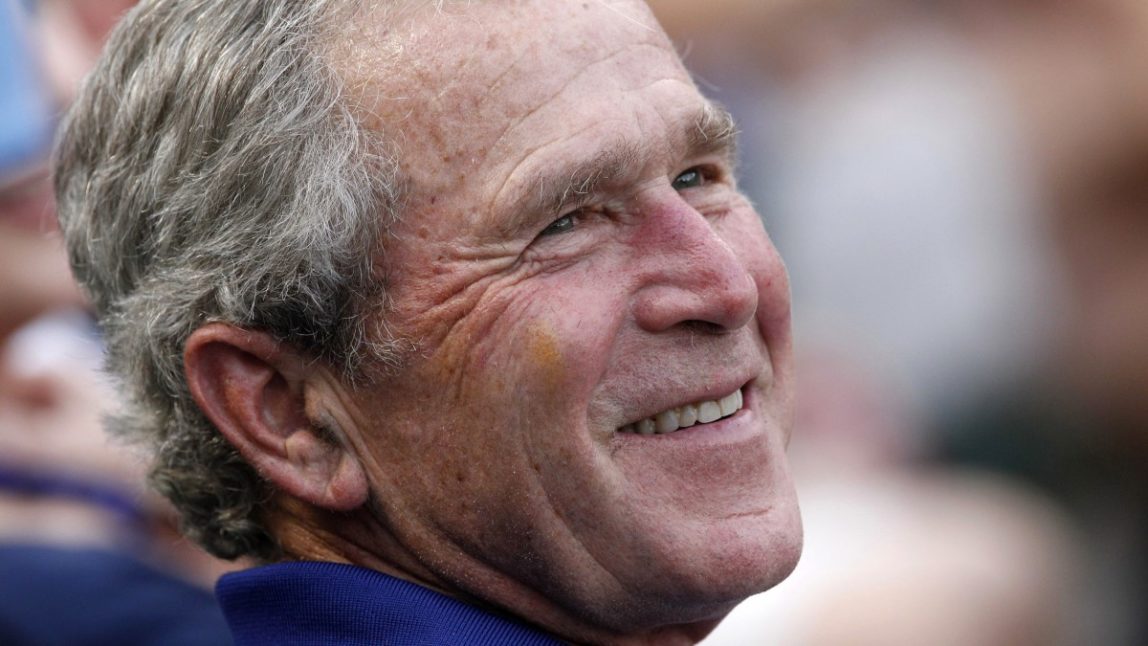 In this June 16, 2012 file photo, former President George W. Bush smiles as he takes in a baseball game in Arlington, Texas. (AP Photo/LM Otero, File)