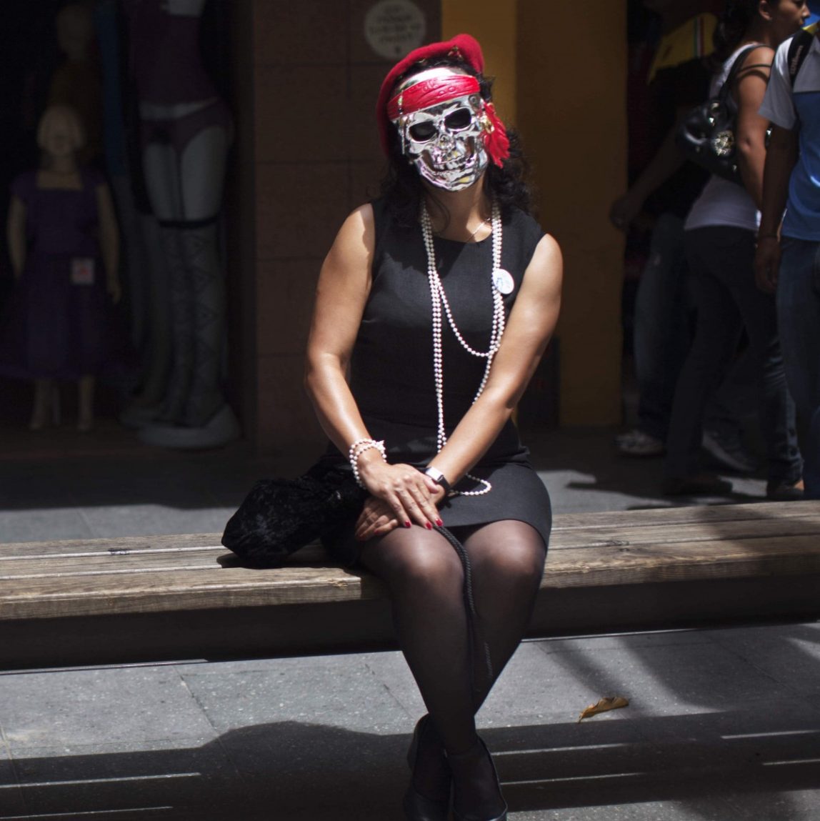 Human rights activist Brenda Hernandez, right, wears a mask saying she's portraying Zury Rios Sosa, daughter of former dictator Efrain Rios Montt, in Guatemala City, Saturday, Sept. 8, 2012. (AP Photo/Rodrigo Abd)