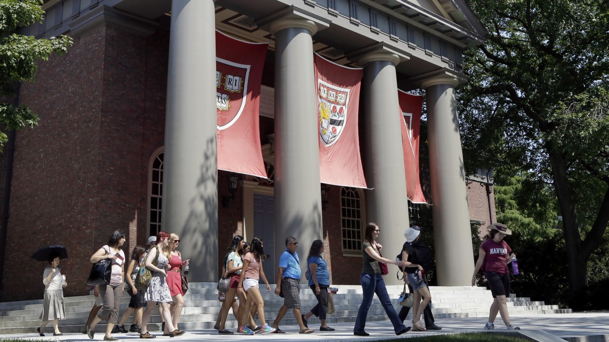 People are led on a tour group at the campus of Harvard University in Cambridge, Mass. Thursday, Aug. 30, 2012. (AP Photo/Elise Amendola)
