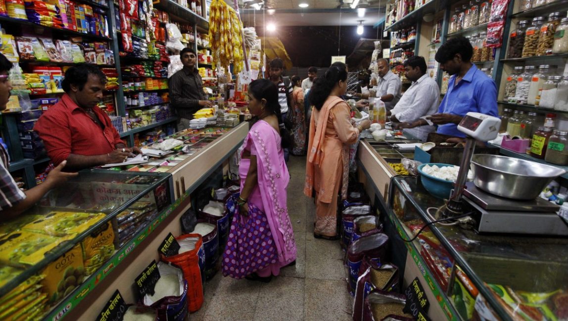 Indian people shop at a store in Mumbai, India, Friday, Sept. 14, 2012. India agreed to open its huge market to foreign retailers such as Wal-Mart as part of a flurry of economic reforms aimed at sparking new growth in the country's sputtering economy. (AP Photo/Rajanish Kakade)
