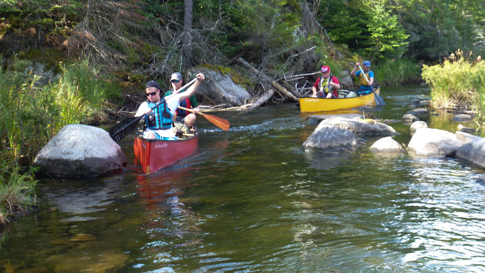 Individuals canoe in the Boundary Waters in northern Minnesota. (Photo Norbert Schiller/MintPress)