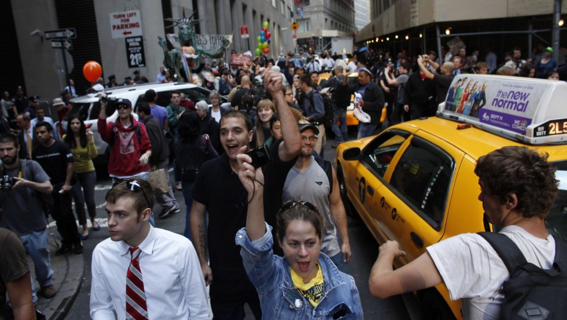 Protesters fill an intersection during an Occupy Wall Street march, Monday, Sept. 17, 2012, in New York. (AP Photo/Jason DeCrow)