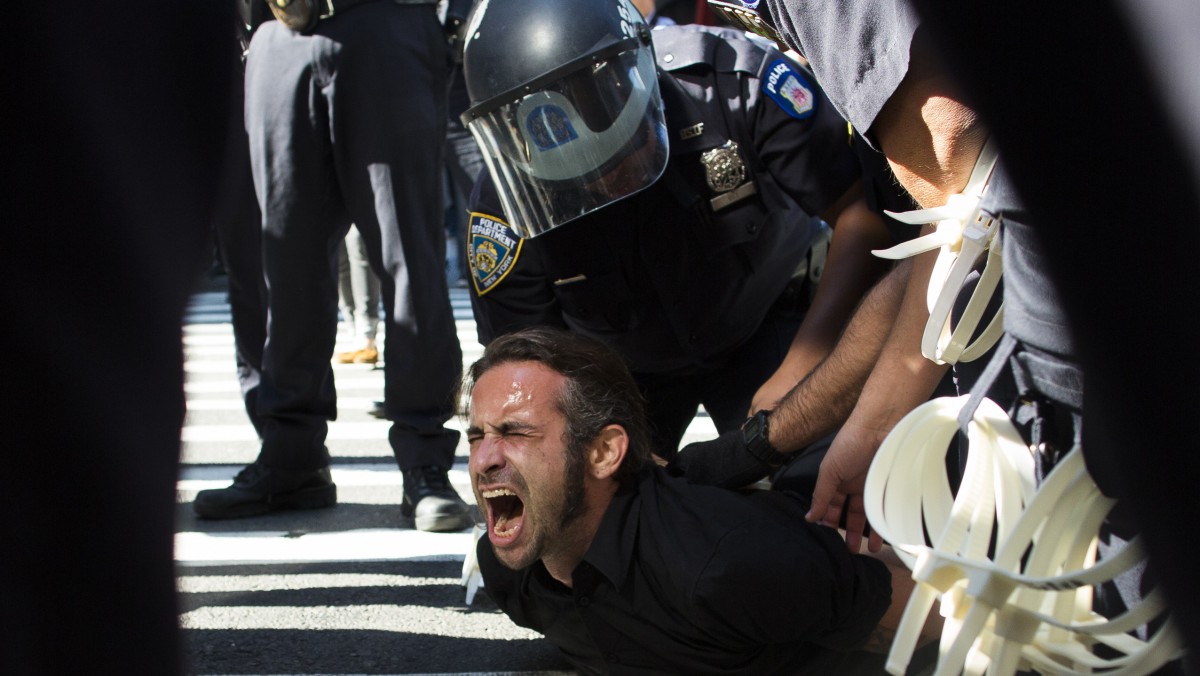 Occupy Wall Street protestor Chris Philips screams as he is arrested near Zuccotti Park, Monday, Sept. 17, 2012, in New York. (AP Photo/John Minchillo)