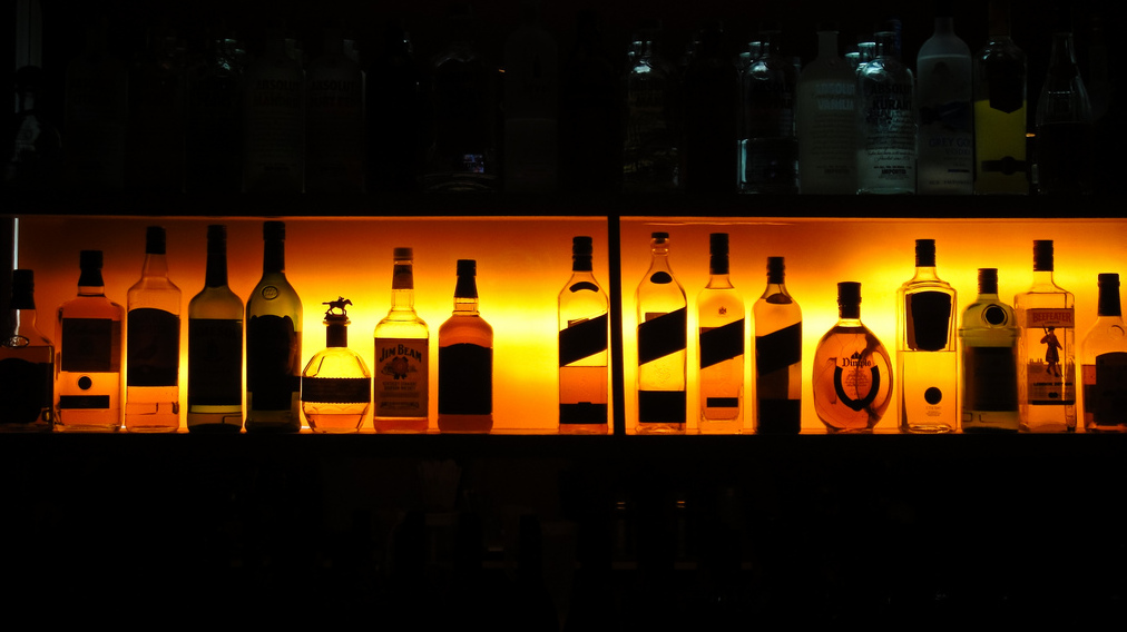 An array of alcoholic beverages lines a shelf in Arizona. (Photo by Jesus Leon via Flikr)