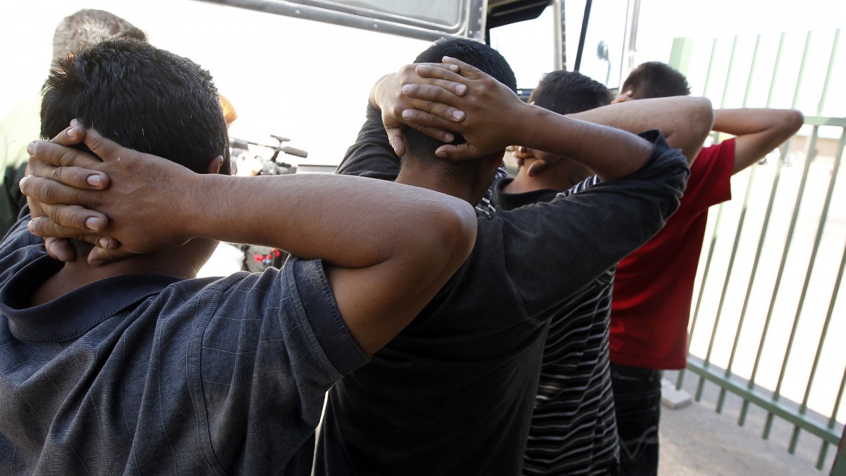 Illegal immigrants prepare to enter a bus after being processed at Tucson Sector U.S. Border Patrol Headquarters Thursday, Aug. 9, 2012, in Tucson, Ariz. (AP Photo/Ross D. Franklin)