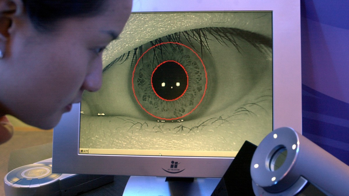 Lee Se-Jung looks into a camera as her eye is seen on the screen beyond, during a presentation of the TrueEYE iris scan system by Korean company Senex Technologies, Thursday March 14, 2002 during the CeBIT computer fair in Hanover, northern Germany. (AP Photo/Fabian Bimmer)