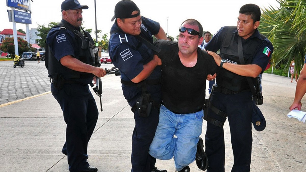 In this photo taken June 8, 2012, former Neo-Nazi leader William A. White is taken into custody by police in the city of Playa del Carmen in Mexico's Mayan Riviera. (AP Photo/Por Esto de Yucatan)
