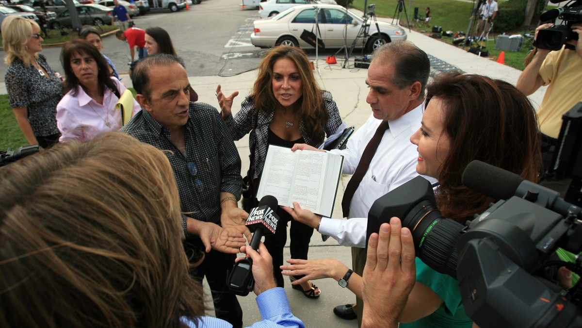 Mohammad Lutfi, left, blogger Pamela Geller and Alan Kornman, of ACT for America, talk in front of the members of the media after a pretrial conference for Rifqa Bary in Orlando, Fla., Tuesday, Oct. 13, 2009. (AP Photo/Ricardo Ramirez Buxeda, POOL)
