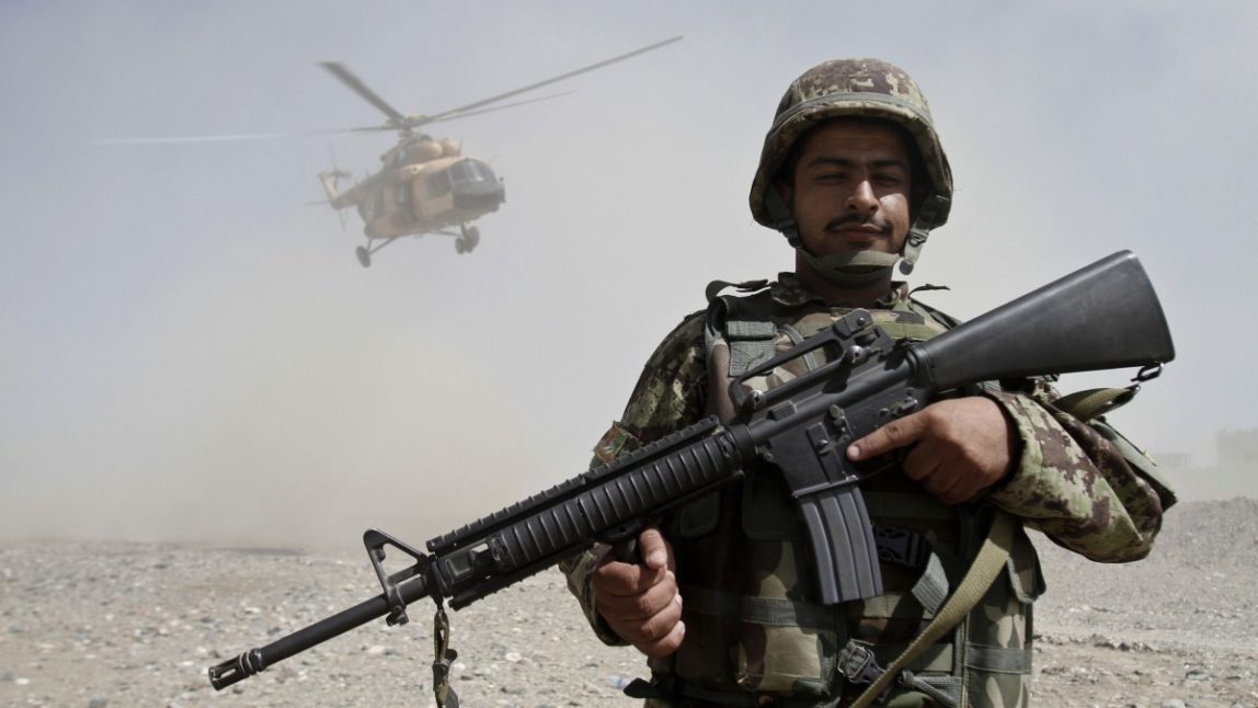 An Afghan soldier stands guard during a gathering in Gushta district of Jalalabad east of Kabul, Afghanistan, Monday, Oct. 1, 2012. (AP Photo/Rahmat Gul)