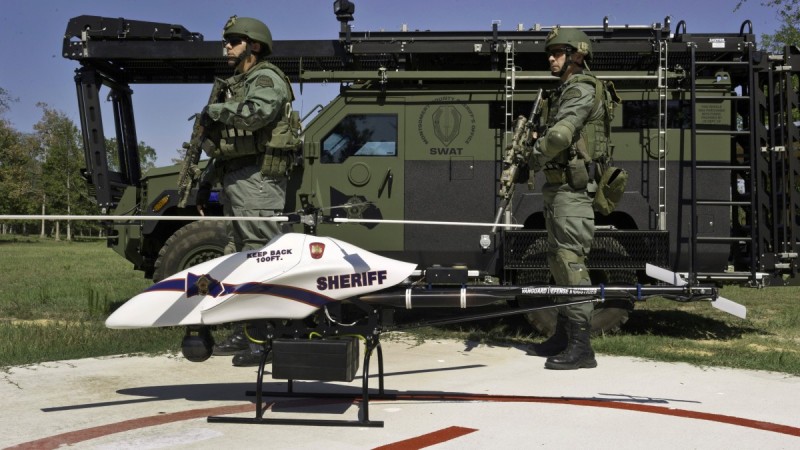 This Sept. 2011 photo provided by Vanguard Defense Industries, shows a ShadowHawk drone with Montgomery County, Texas, SWAT team members. (AP Photo/Lance Bertolino, Vanguard Defense Industries)