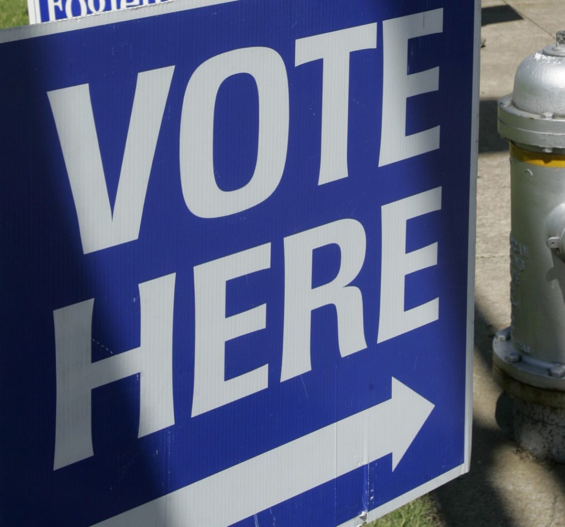 This May 3, 2010 file photo shows a "vote here" sign near a polling place open for early voting in downtown Little Rock, Ark. (AP Photo/Danny Johnston, File)