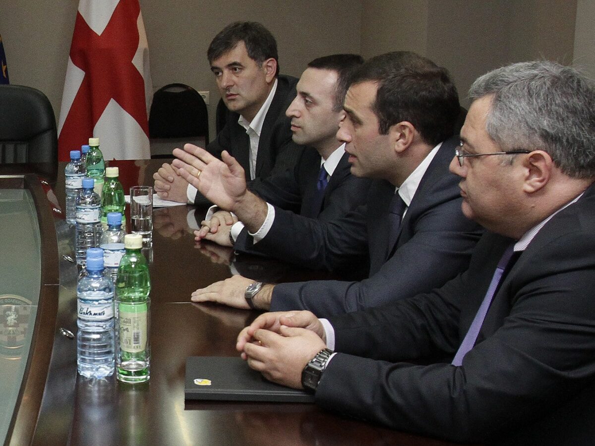 Representatives of the ruling United National Movement, left, meet with representatives of the opposition Georgian Dream coalition at the government office in Tbilisi, Friday, Oct. 5, 2012. (AP Photo/David Mdzinarishvili, pool)
