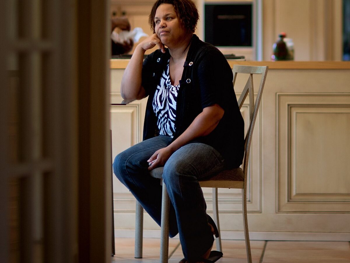 Yhonna Flowers sits in the home she shares with her four children and her mother, retired Atlanta police Det. Jaqueline Barber, Monday, Oct. 8, 2012, in Fayetteville, Ga. (AP Photo/David Goldman)