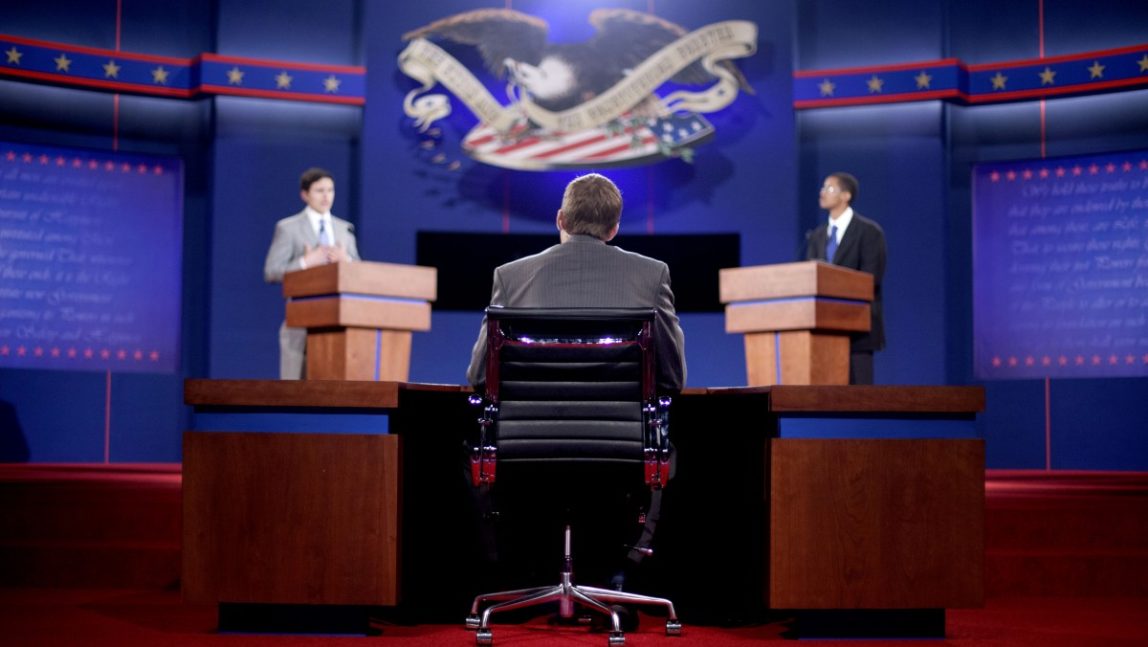 Stand-ins for moderator Jim Lehrer, center, Republican presidential candidate, former Massachusetts Gov. Mitt Romney, left, and President Barack Obama, right, run through a rehearsal for a debate at the University of Denver Tuesday, Oct. 2, 2012, in Denver. (AP Photo/David Goldman)