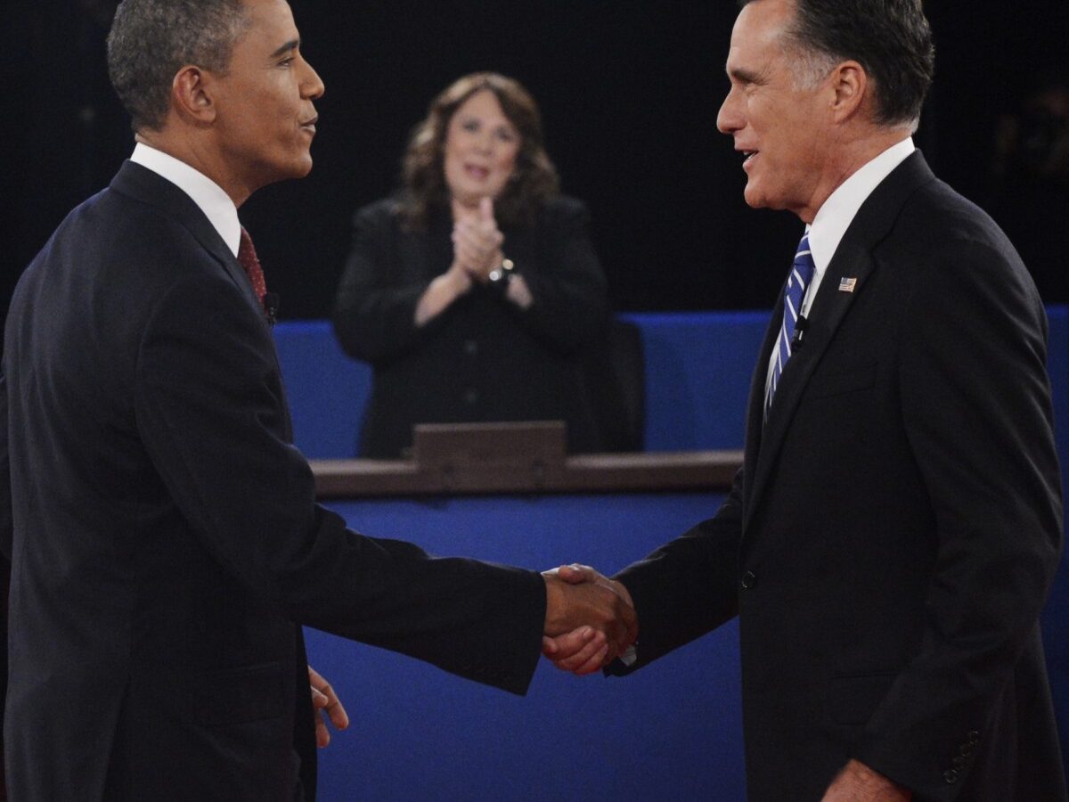 Moderator Candy Crowley, center, applauds as President Barack Obama, right, shakes hands with Republican presidential nominee Mitt Romney during the second presidential debate at Hofstra University, Tuesday, Oct. 16, 2012, in Hempstead, N.Y. (AP Photo/Pool-Michael Reynolds)