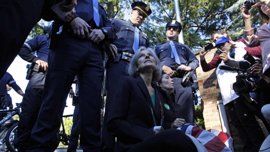 Green Party presidential candidate Jill Stein, left, and vice presidential candidate Cheri Honkala sit at the entrance to Hofstra University, Hempstead, N.Y., Tuesday, Oct. 16, 2012, after being informed that they wouldn't be able to enter and participate in the second presidential debate. (AP Photo/Mary Altaffer)