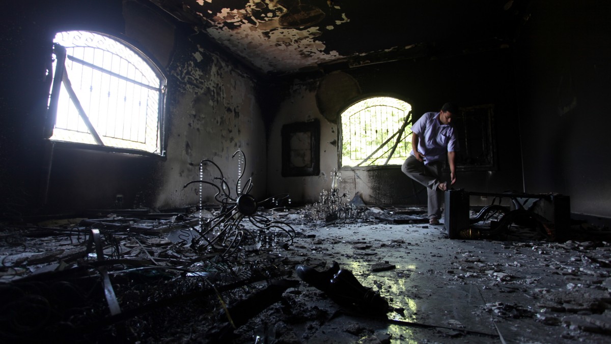 In this Sept. 13, 2012 file photo, a Libyan man investigates the inside of the U.S. Consulate, after an attack that killed four Americans, including Ambassador Chris Stevens on the night of Tuesday, Sept. 11, 2012, in Benghazi, Libya. (AP Photo/Mohammad Hannon, File)