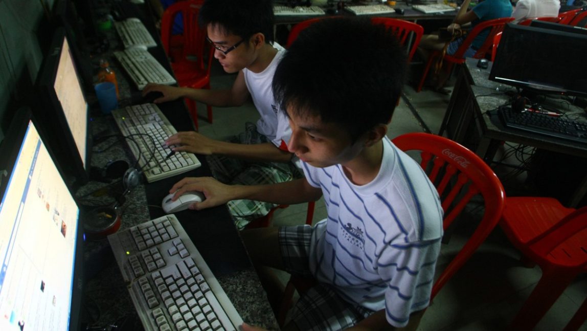 Two Vietnamese students use Facebook at an internet cafe near their domertary while they could not log in Facebook from their mobile phones because of firewalled on 27 September 2012 in Hanoi, Vietnam. (AP Photo/Na Son Nguyen)
