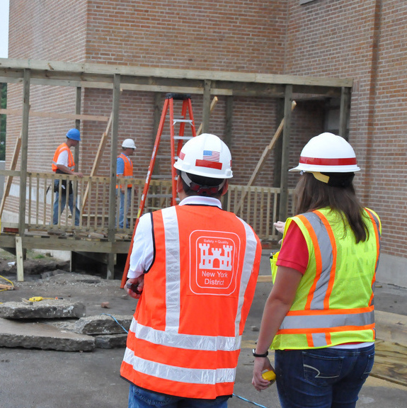 Construction workers walk through a construction area on June 20, 2011. (Photo by the US Army Corps of Engineers via Flikr)