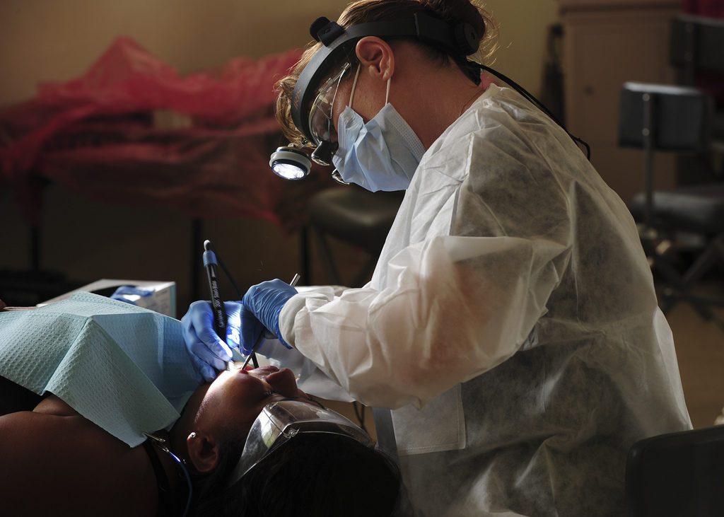 Hospital Corpsman 1st Class Kimberly Edwards, from Louisville, Ky., cleans the teeth of a patient. (U.S. Navy photo by Mass Communication Specialist 1st Class Brian A. Goyak/Released)