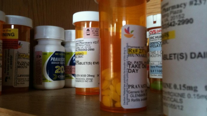 Prescription drugs line a cabinet in this March 25, 2011 photo. (Photo by Eric Hunsaker via Flikr)