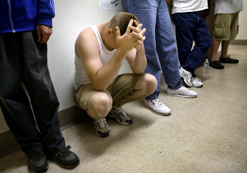 Dave McBee, left, a U.S. Marine combat veteran of the Iraq War waits in the "med line" at the "Soldier On" veterans homeless shelter, in Leeds, Mass., Friday, July 18, 2008. (AP Photo/Steven Senne)