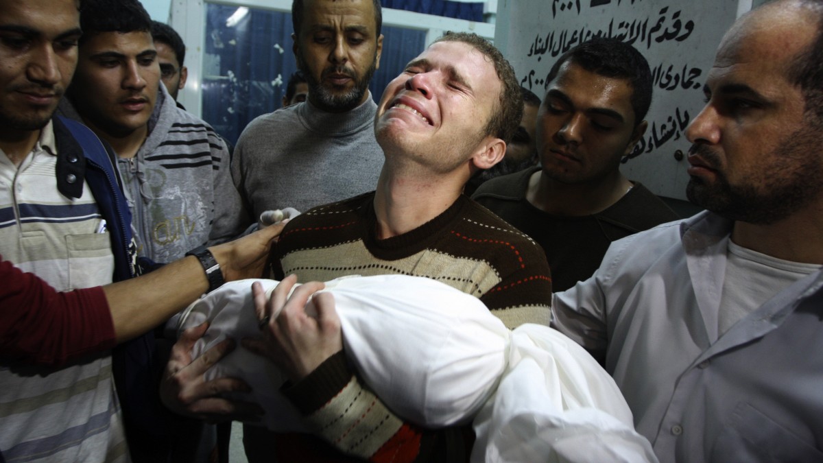Jihad Masharawi weeps while he holds the body of his 11-month old son Ahmad, at Shifa hospital following an Israeli air strike on their family house, in Gaza City, Wednesday, Nov. 14, 2012. (AP Photo/Majed Hamdan)
