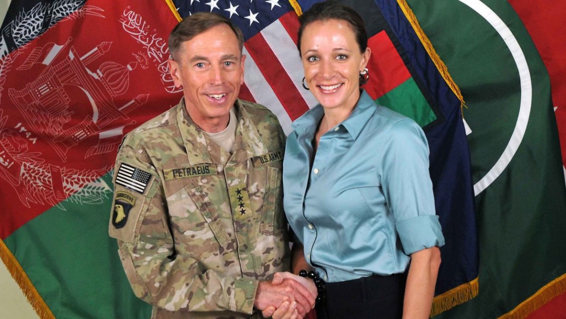 Gen. Davis Petraeus, left, shaking hands with soon to be mistress, Paula Broadwell, co-author of "All In: The Education of General David Petraeus." (AP Photo/ISAF)