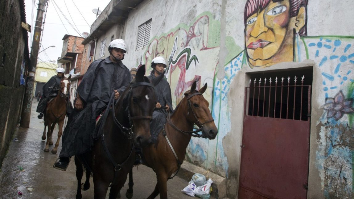 Mounted military police patrol in the Paraisopolis slum of Sao Paulo, Brazil, early Tuesday, Nov. 13, 2012. (AP Photo/Andre Penner)