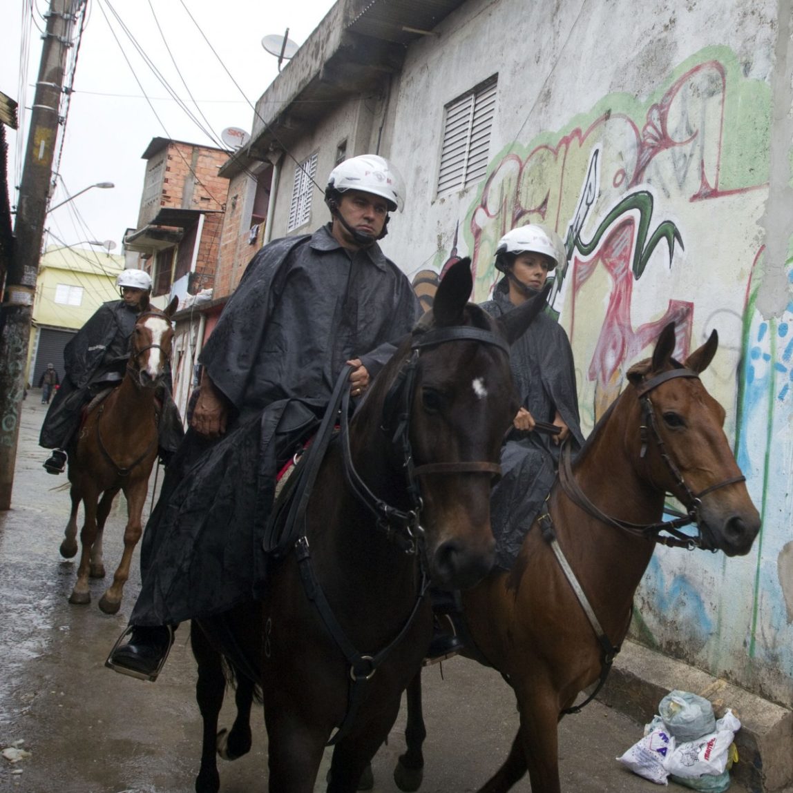 Mounted military police patrol in the Paraisopolis slum of Sao Paulo, Brazil, early Tuesday, Nov. 13, 2012. (AP Photo/Andre Penner)