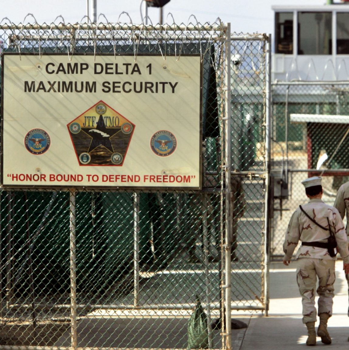 In this June 27, 2006 file photo, reviewed by a U.S. Department of Defense official, U.S. military guards walk within Camp Delta military-run prison, at the Guantanamo Bay U.S. Naval Base, Cuba. (AP Photo/Brennan Linsley, File)