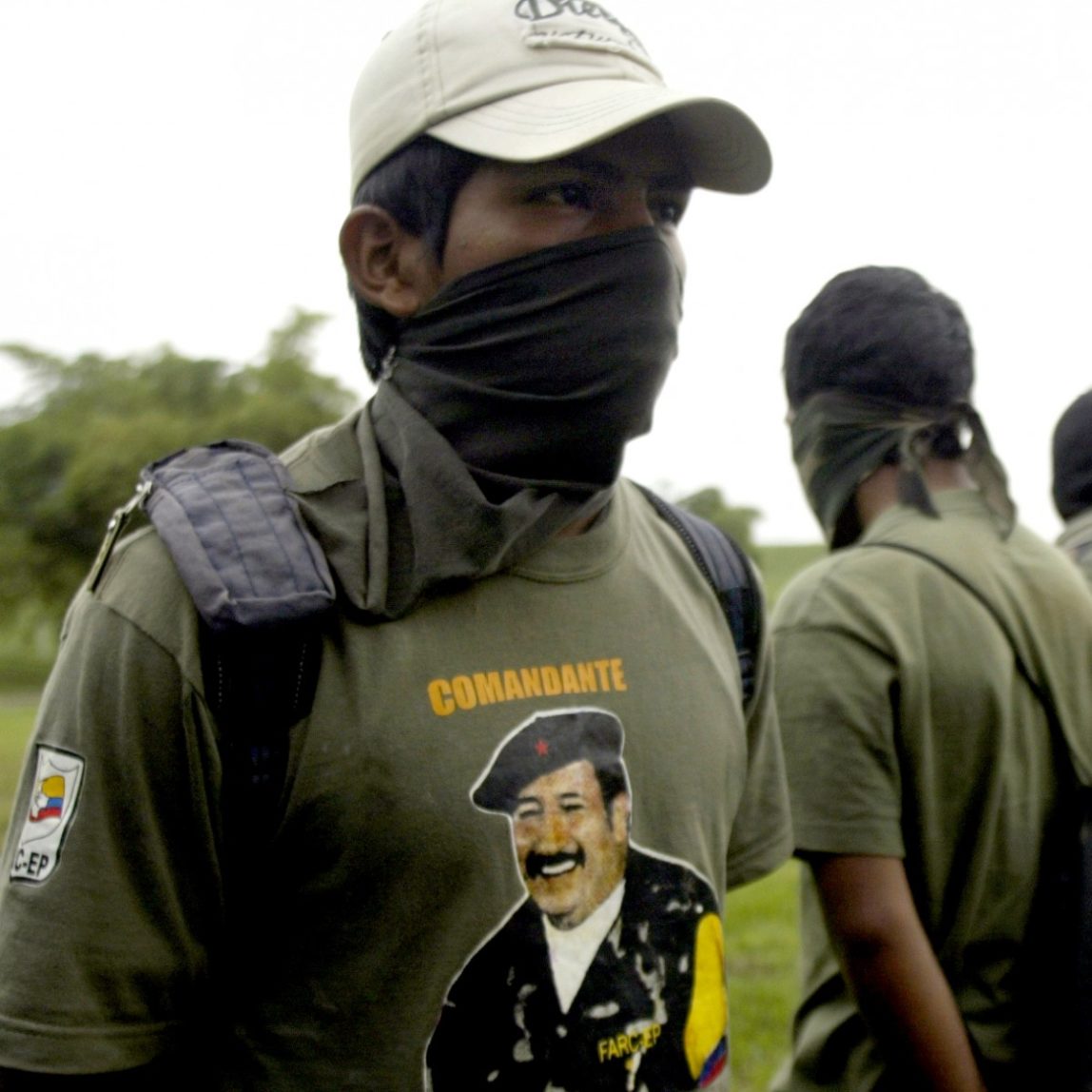 In this Monday, June 23, 2008, file photo, a member of the Revolutionary Armed Forces of Colombia, FARC stands with his face covered at a military base in Cali, Colombia. (AP Photo/Christian Escobar Mora)