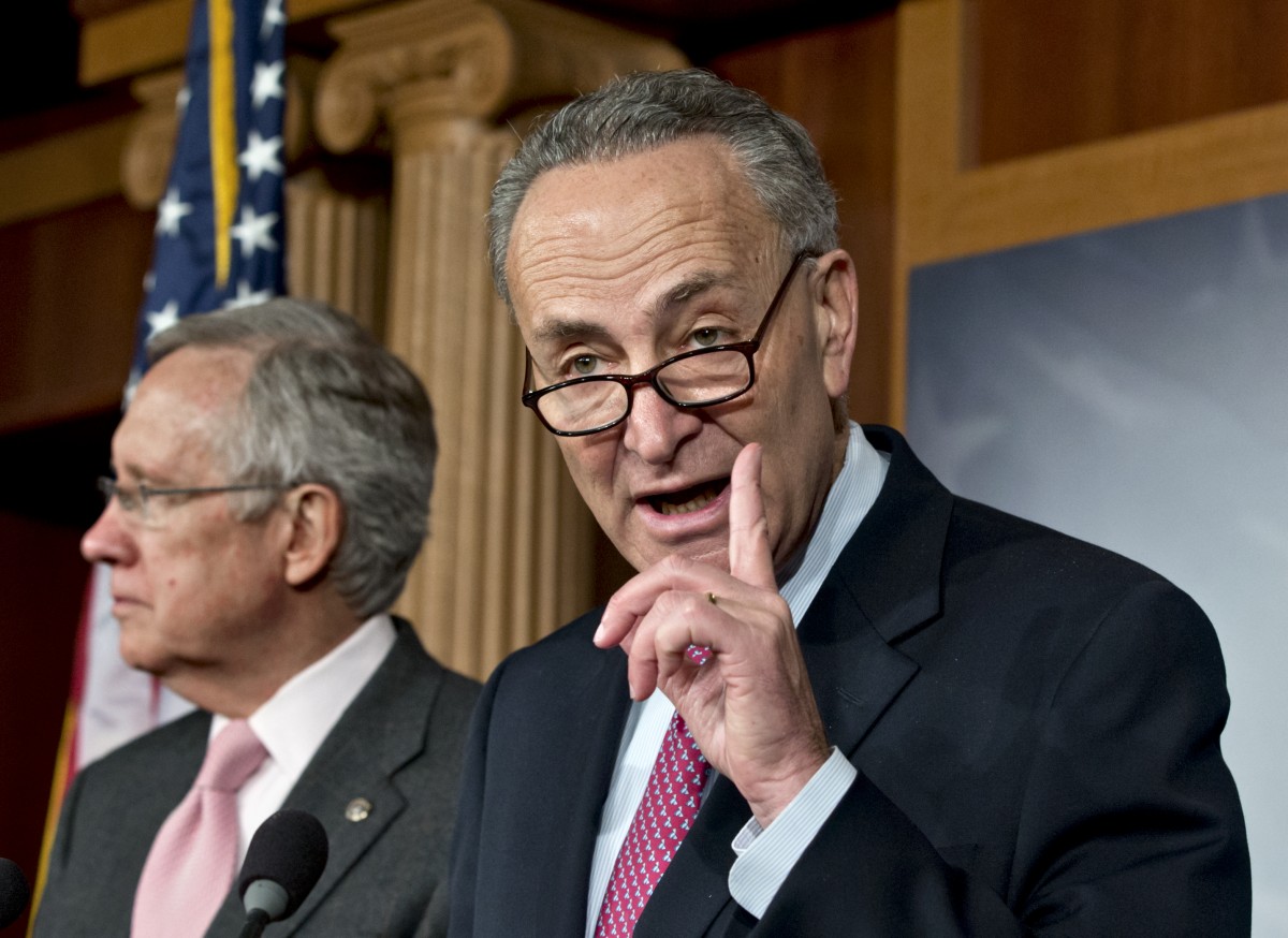 Sen. Charles Schumer, D-N.Y., right, accompanied by Senate Majority Leader Harry Reid of Nev., gestures during a news conference on Capitol Hill in Washington, Thursday, Nov. 29, 2012. (AP Photo/J. Scott Applewhite)