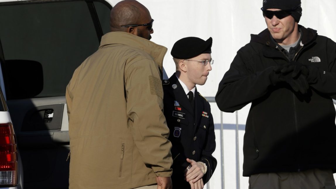 Army Pfc. Bradley Manning, second from right, steps out of a security vehicle as he is escorted into a courthouse in Fort Meade, Md., Thursday, Nov. 29, 2012, for a pretrial hearing. (AP Photo/Patrick Semansky)