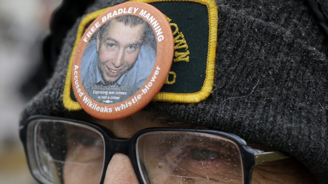Demonstrator Richard Ochs wears a button in support of Army Pfc. Bradley Manning as he stands outside of Fort Meade, Md., Tuesday, Nov. 27, 2012, where Manning was scheduled to appear for a pretrial hearing. (AP Photo/Patrick Semansky)
