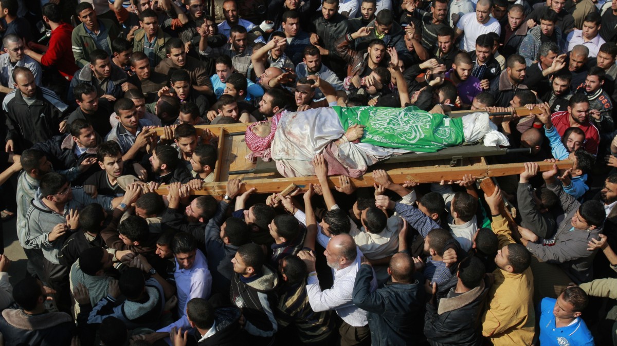 Palestinian mourners carry the body of Hamas' top military commander Ahmed Jabari, killed in an Israeli strike on Wednesday, during his funeral in Gaza City, Thursday, Nov. 15, 2012. (AP Photo/Adel Hana)